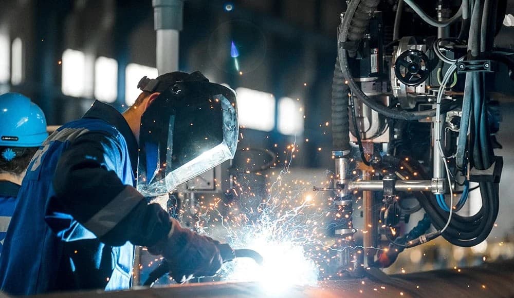 Team of construction workers in PPE at industrial site